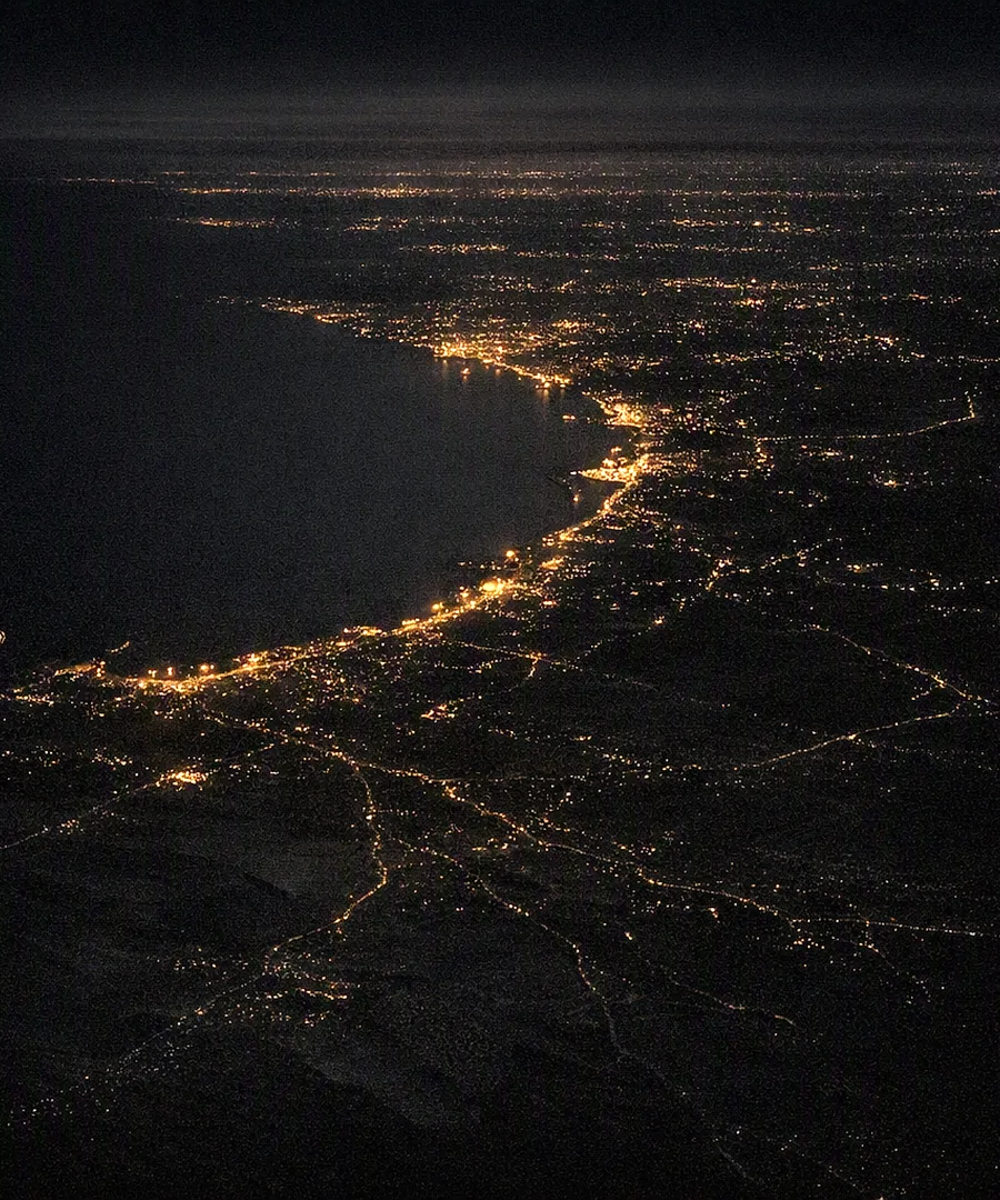 The UAE coastline lit up at night, from the air
